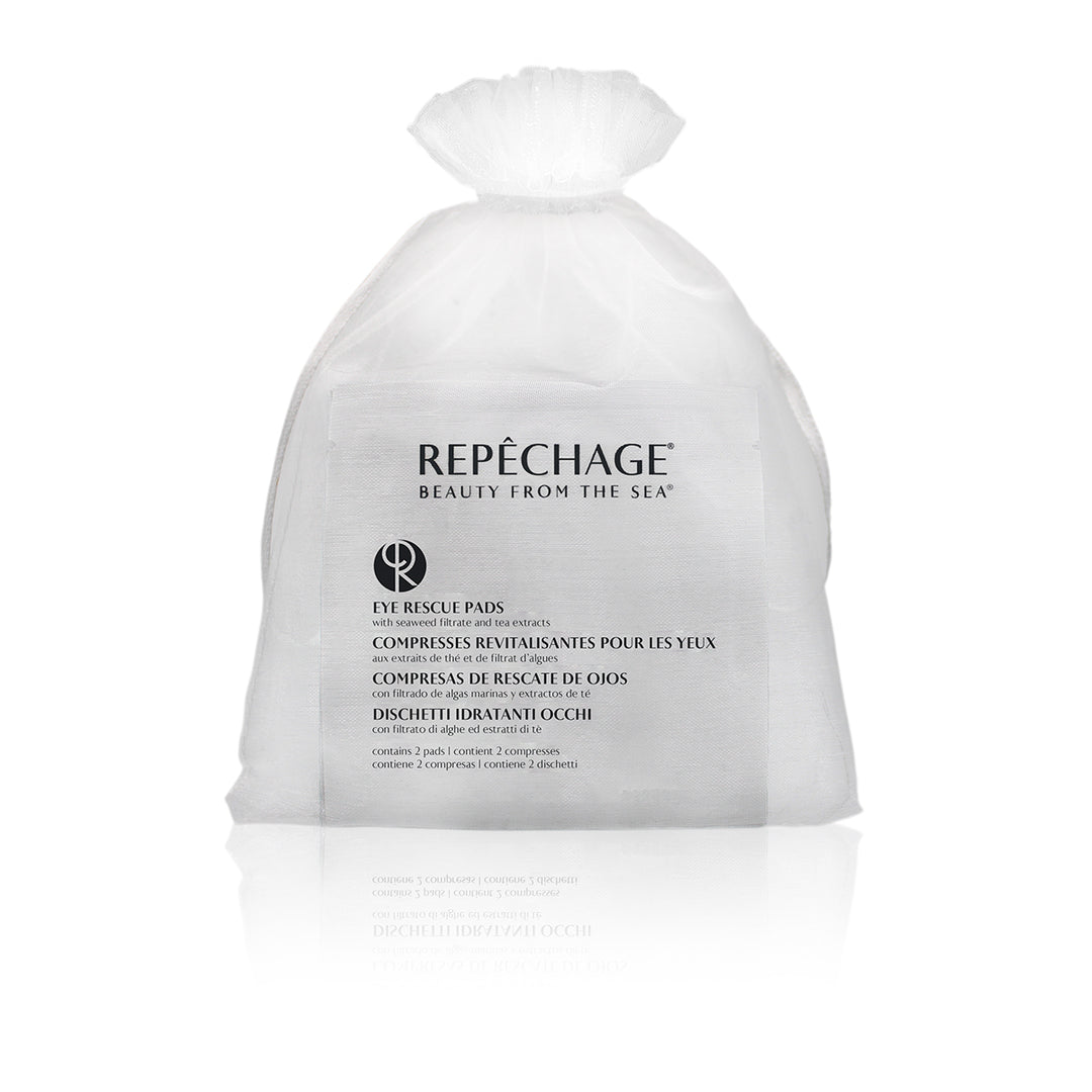 A sealed, white sachet labeled REPECHAGE with eye rescue pads visible through a small opening at the top.