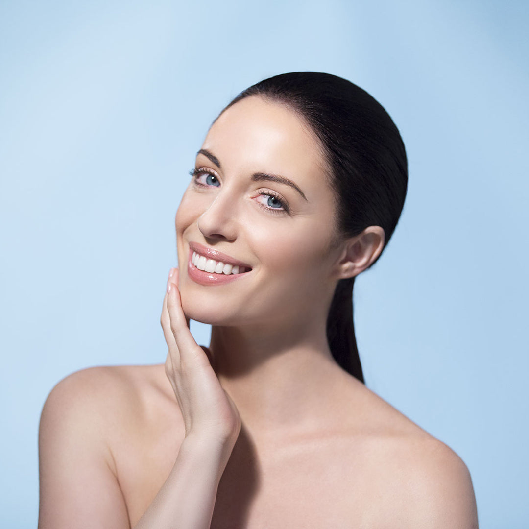 Female model with clear skin smiling at camera