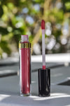 Opened Mantra Perfect Skin Conditioning Lip Gloss standing upright on table outside