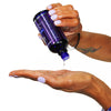 Pouring Hydra-Amino 18 Hair Spa Serum bottle into hand