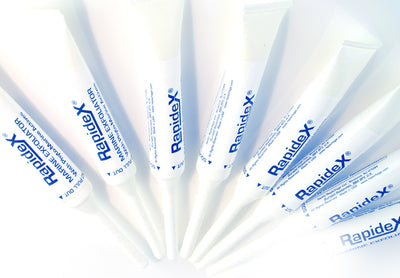 Eight Rapidex Marine Exfoliator Tubes laying in a row
